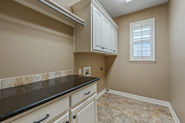 5524 Hollytree, Tyler, TX 75703 - washroom featuring hookup for an electric dryer, baseboards, washer hookup, and cabinet space