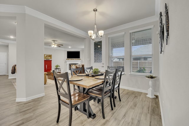 208 Beechcraft Ct, Caddo Mills, TX 75135 - dining room featuring a fireplace, light wood-type flooring, baseboards, ceiling fan, and crown molding