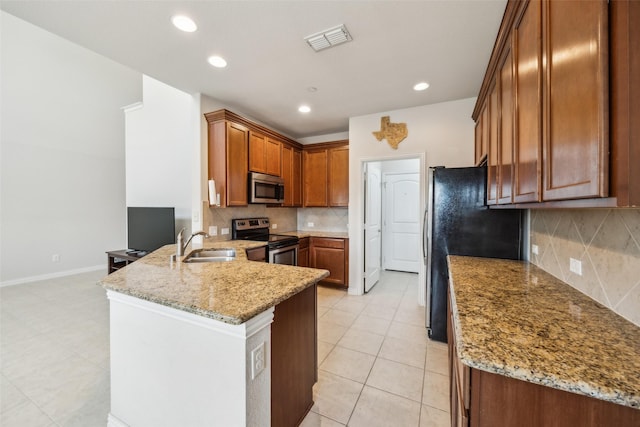 6552 Federal Hall St, Plano, TX 75023 - kitchen with stainless steel appliances, a peninsula, a sink, light stone countertops, and decorative backsplash