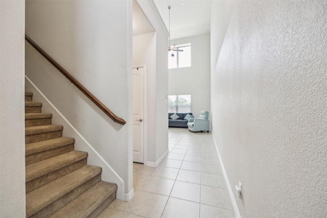 6552 Federal Hall St, Plano, TX 75023 - staircase featuring tile patterned floors, baseboards, and a towering ceiling