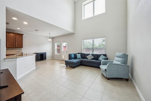 6552 Federal Hall St, Plano, TX 75023 - living area featuring recessed lighting, light tile patterned floors, baseboards, and a towering ceiling