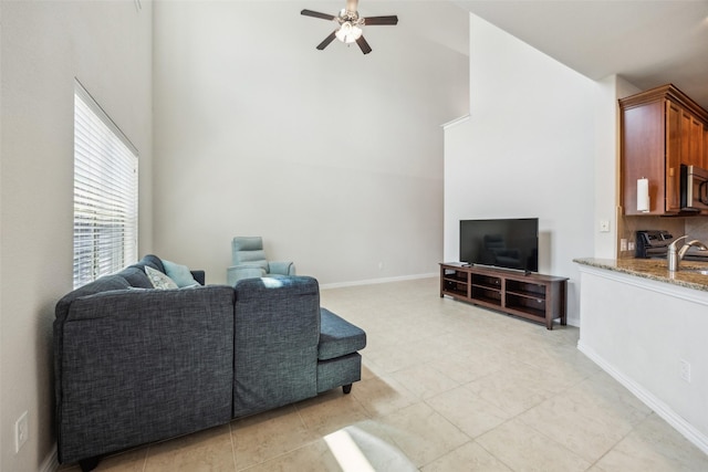 6552 Federal Hall St, Plano, TX 75023 - living area with high vaulted ceiling, ceiling fan, light tile patterned flooring, and baseboards