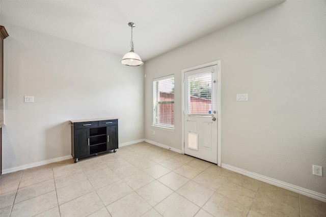 6552 Federal Hall St, Plano, TX 75023 - unfurnished dining area featuring baseboards and light tile patterned flooring