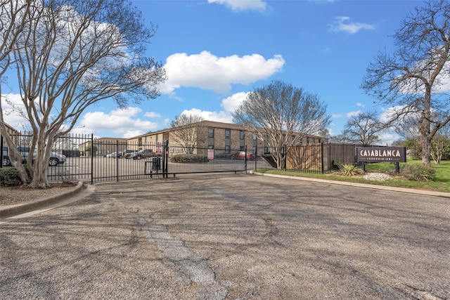 1226 Baylor Ave Unit 116, Waco, TX 76706 - view of asphalt road featuring curbs, a gate, and a gated entry