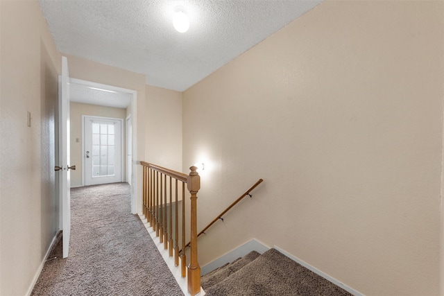 1226 Baylor Ave Unit 116, Waco, TX 76706 - staircase with carpet flooring, a textured ceiling, and baseboards