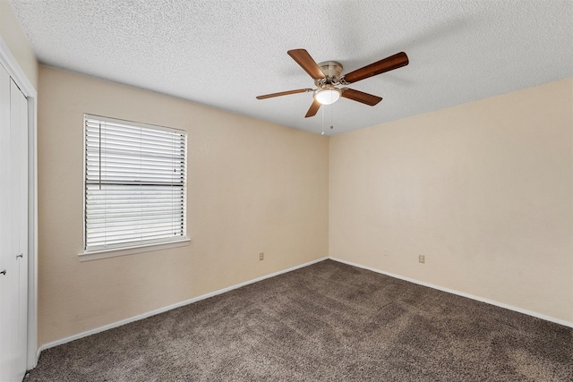 1226 Baylor Ave Unit 116, Waco, TX 76706 - empty room with ceiling fan, dark carpet, baseboards, and a textured ceiling