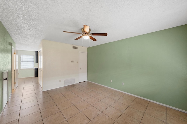 1226 Baylor Ave Unit 116, Waco, TX 76706 - unfurnished room with a ceiling fan, a textured ceiling, light tile patterned floors, and baseboards