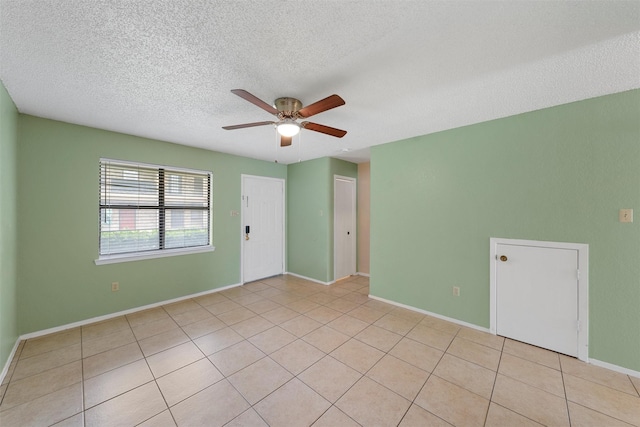 1226 Baylor Ave Unit 116, Waco, TX 76706 - empty room featuring a ceiling fan, a textured ceiling, baseboards, and light tile patterned flooring