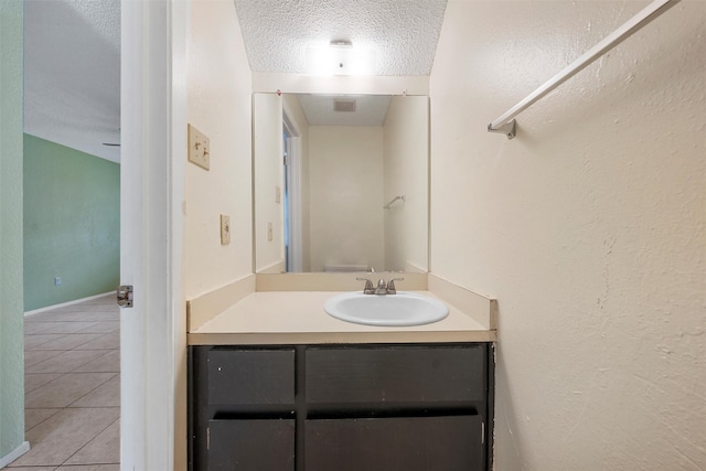 1226 Baylor Ave Unit 116, Waco, TX 76706 - bathroom with a textured ceiling, tile patterned flooring, and vanity