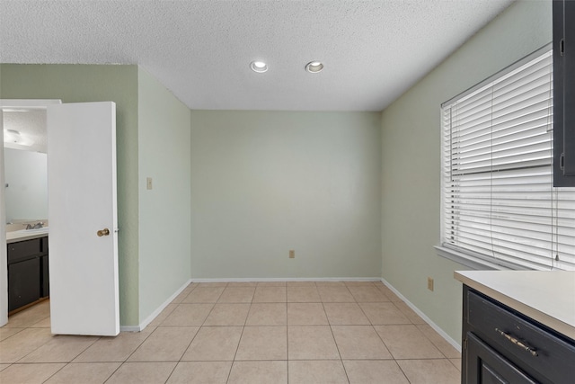 1226 Baylor Ave Unit 116, Waco, TX 76706 - spare room with a textured ceiling, light tile patterned flooring, plenty of natural light, recessed lighting, and a sink