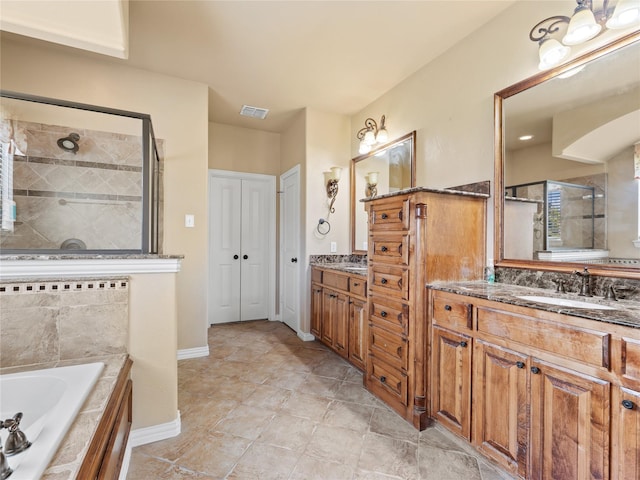 1413 Prairie Dr, Carrollton, TX 75007 - full bathroom featuring a stall shower, a bath, vanity, and baseboards