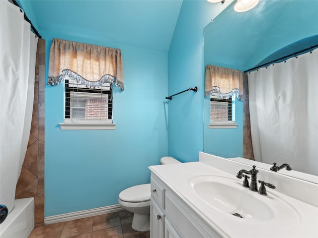 1413 Prairie Dr, Carrollton, TX 75007 - bathroom with lofted ceiling, toilet, vanity, baseboards, and tile patterned floors