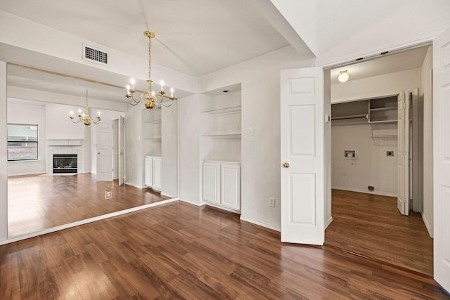 1120 Forest Creek St, Benbrook, TX 76126 - unfurnished dining area featuring a chandelier, wood finished floors, a tiled fireplace, and baseboards