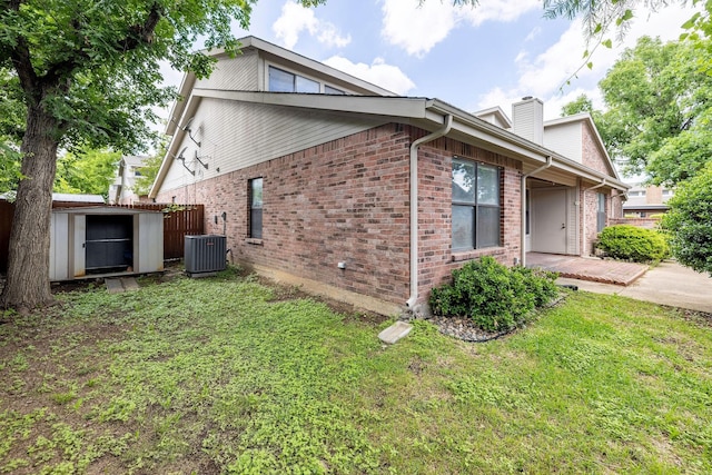 1120 Forest Creek St, Benbrook, TX 76126 - view of property exterior with a storage unit, brick siding, cooling unit, and a yard