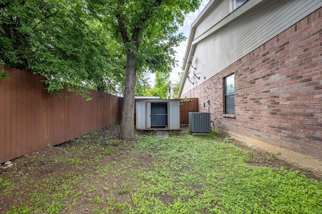 1120 Forest Creek St, Benbrook, TX 76126 - view of yard with central AC unit, fence, a shed, and an outdoor structure