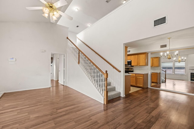 1120 Forest Creek St, Benbrook, TX 76126 - unfurnished living room with a high ceiling, a chandelier, stairway, wood finished floors, and a ceiling fan
