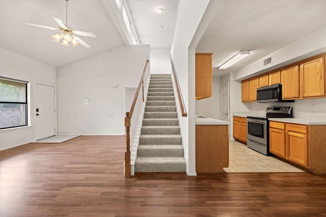 1120 Forest Creek St, Benbrook, TX 76126 - kitchen featuring stainless steel appliances, ceiling fan, light countertops, vaulted ceiling, and light wood finished floors