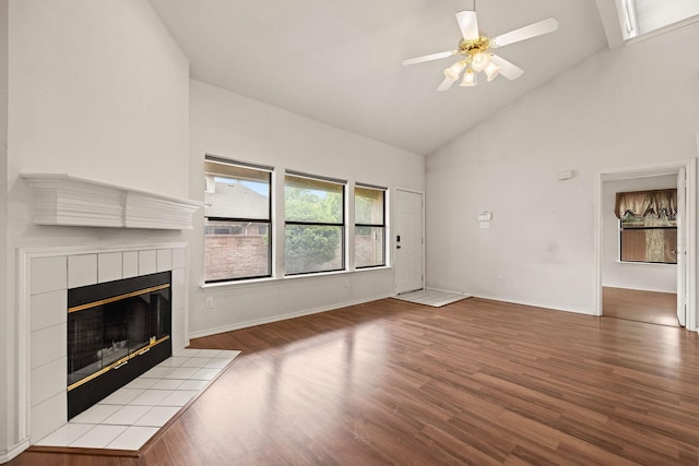 1120 Forest Creek St, Benbrook, TX 76126 - unfurnished living room with a tile fireplace, high vaulted ceiling, wood finished floors, ceiling fan, and baseboards