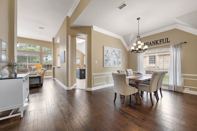 1820 Lacey Oak Ln, Keller, TX 76248 - dining area featuring lofted ceiling, dark wood-style floors, a chandelier, a wainscoted wall, and a decorative wall