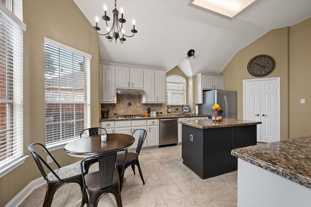 1820 Lacey Oak Ln, Keller, TX 76248 - kitchen featuring stainless steel appliances, vaulted ceiling, a center island, tasteful backsplash, and a chandelier
