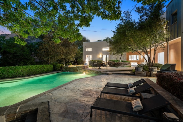 view of pool featuring a patio area and a pool with connected hot tub