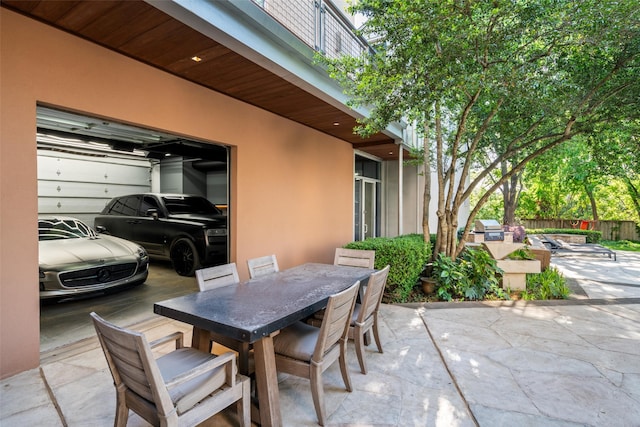 view of patio with outdoor dining space and fence