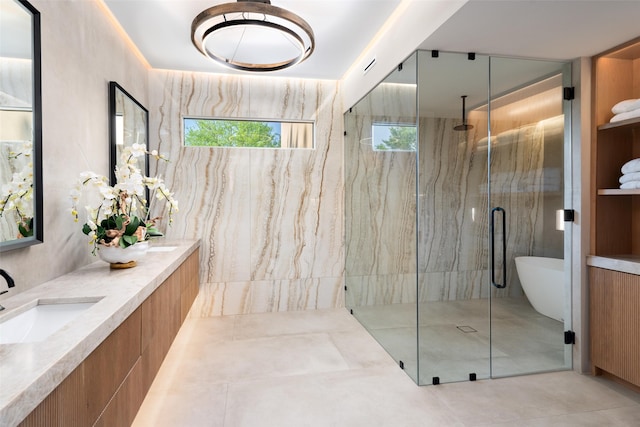full bathroom featuring a marble finish shower, tile patterned flooring, and double vanity