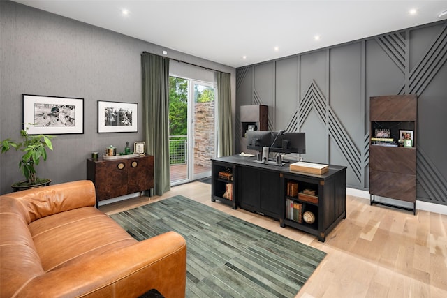 office featuring light wood-type flooring, a decorative wall, and recessed lighting