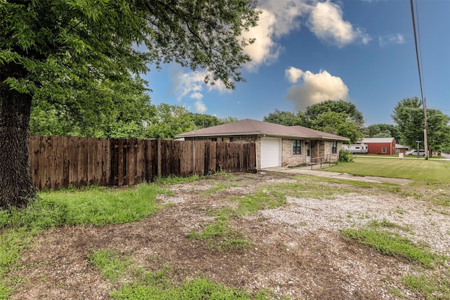 204 E 2nd St, Quinlan, TX 75474 - rear view of property with a garage, driveway, and brick siding
