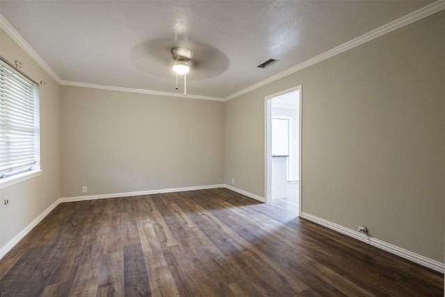 204 E 2nd St, Quinlan, TX 75474 - empty room featuring a ceiling fan, dark wood-type flooring, baseboards, and ornamental molding