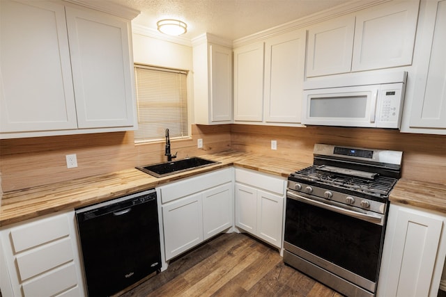 204 E 2nd St, Quinlan, TX 75474 - kitchen with butcher block counters, white microwave, stainless steel gas stove, dishwasher, and a sink