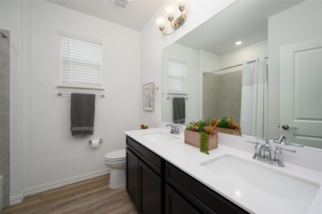 full bathroom with wood finished floors, toilet, baseboards, and a shower with curtain