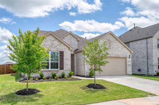 view of front facade with an attached garage, driveway, brick siding, and a shingled roof