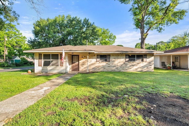 single story home with a front lawn and brick siding