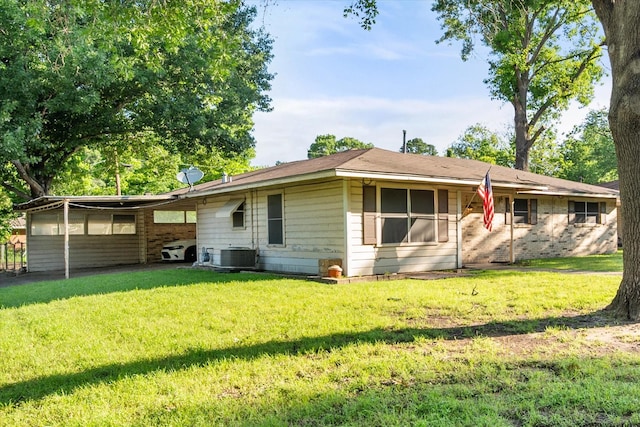 view of front facade featuring a front yard, central AC, and brick siding
