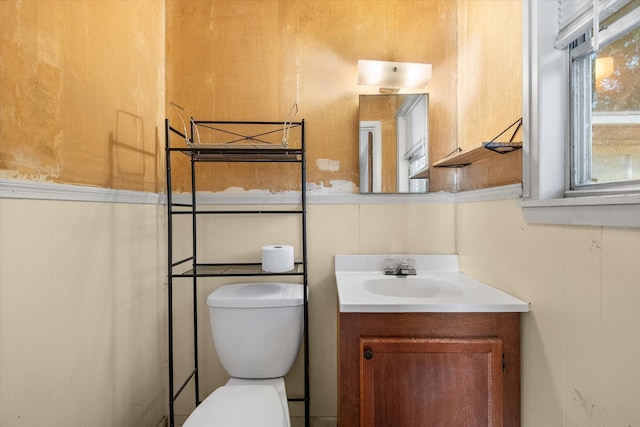 half bathroom with vanity and toilet