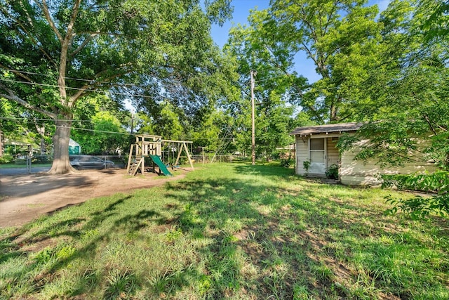 view of yard with a playground and an outdoor structure