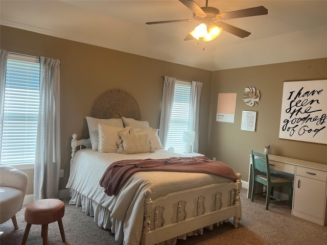 bedroom with light colored carpet, baseboards, and a ceiling fan