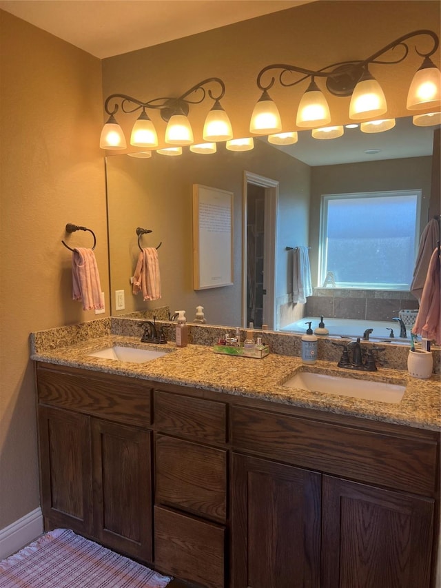 bathroom featuring double vanity and a garden tub