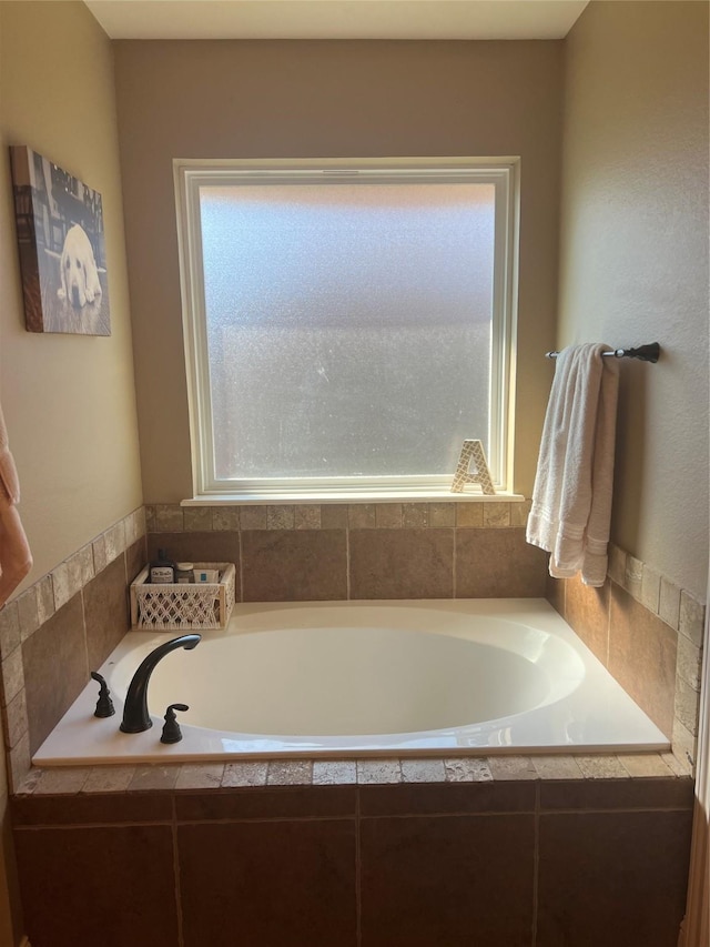 bathroom with plenty of natural light and a garden tub