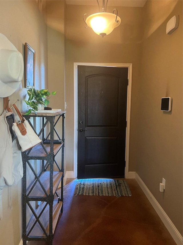 entryway featuring baseboards and carpet flooring