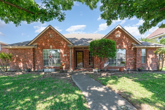 6707 Foxglove Trl, Sachse, TX 75048 - view of front facade featuring brick siding, a front lawn, and a shingled roof