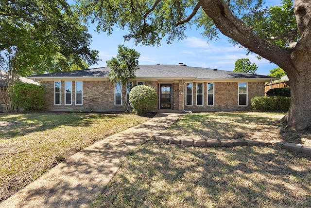 ranch-style home with brick siding and a front yard