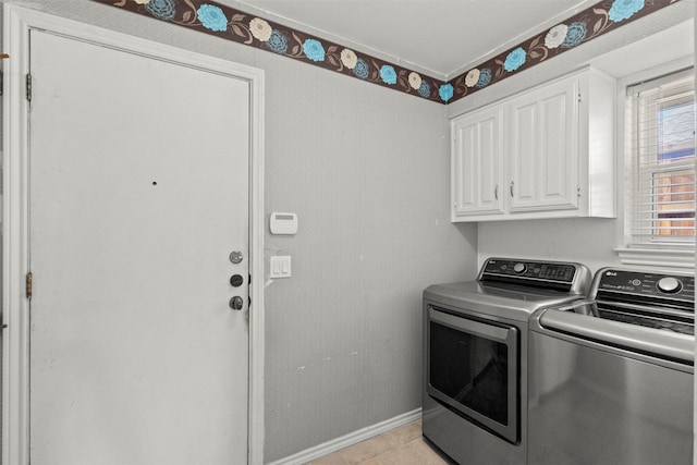 laundry area featuring cabinet space, washer and clothes dryer, baseboards, and light tile patterned floors