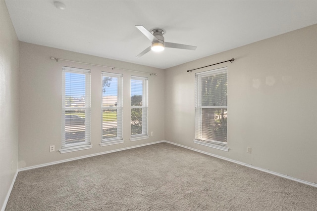 empty room featuring ceiling fan, carpet flooring, and baseboards
