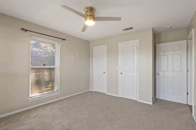 unfurnished bedroom with carpet, baseboards, and a ceiling fan