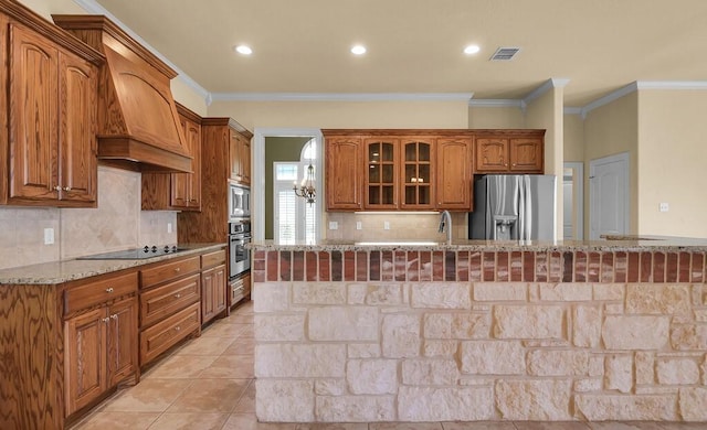 1105 Charing Cross Dr, Waco, TX 76712 - kitchen with appliances with stainless steel finishes, custom exhaust hood, light stone countertops, ornamental molding, and glass insert cabinets