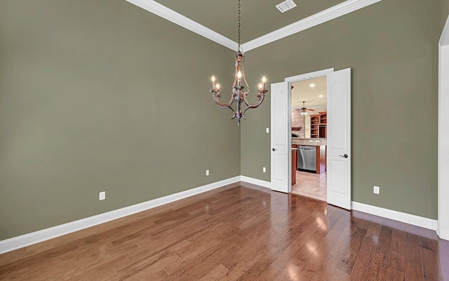 1105 Charing Cross Dr, Waco, TX 76712 - unfurnished dining area with crown molding, a chandelier, baseboards, wood finished floors, and ceiling fan