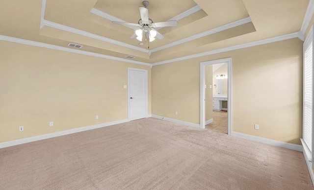 1105 Charing Cross Dr, Waco, TX 76712 - spare room featuring a tray ceiling, a ceiling fan, ornamental molding, light carpet, and baseboards
