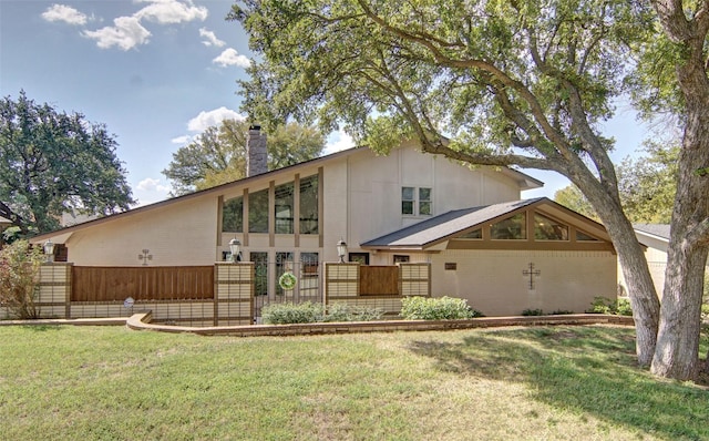 1022 Kintner Dr, Graham, TX 76450 - rear view of house with a chimney, brick siding, and a gate